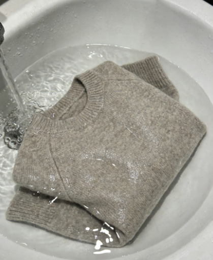 The cashmere sweater was completely soaked in water